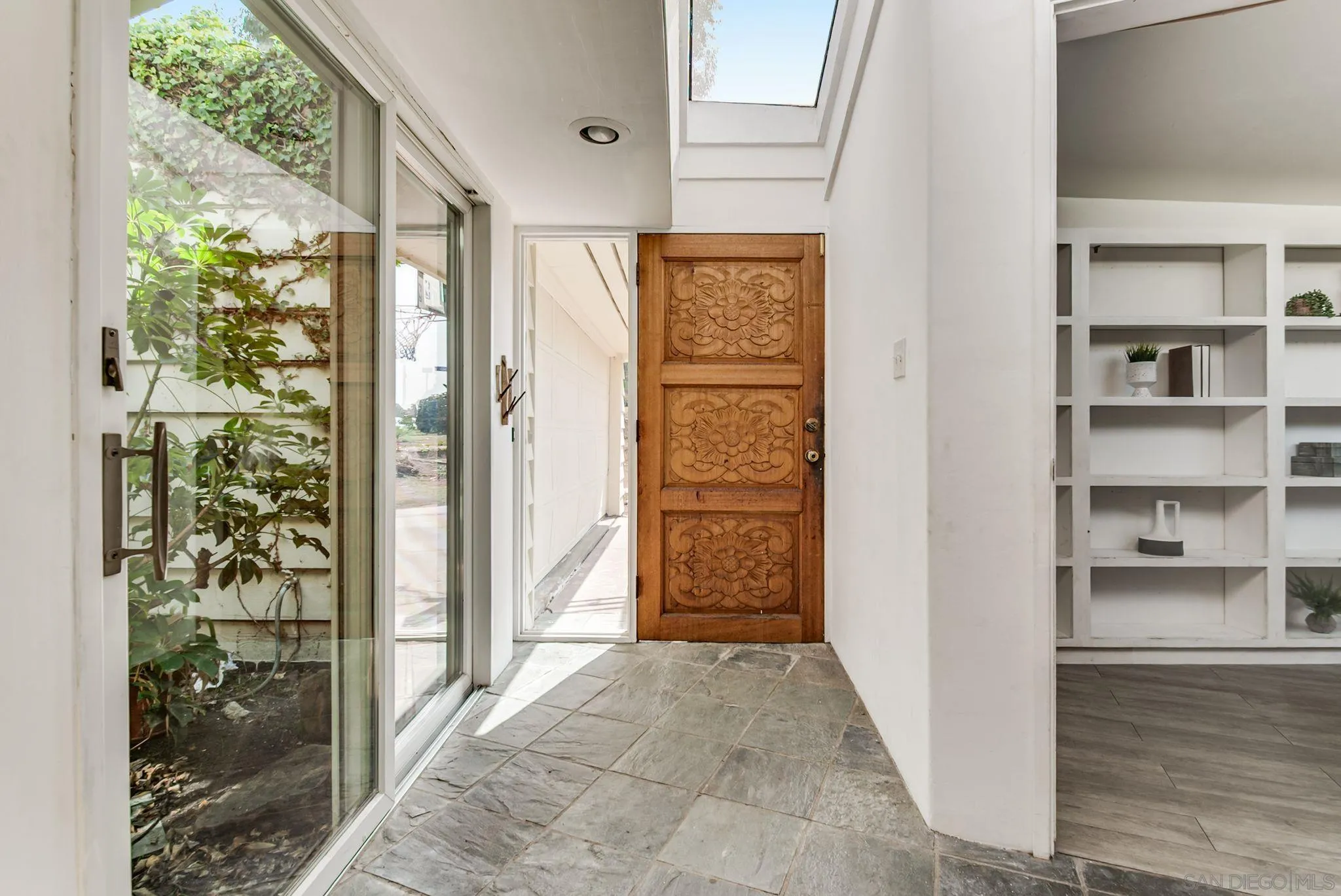 624 8th Street Del Mar, CA 92014 - Photo 12 of 25 a view of a hallway with wooden shelves and entryway
