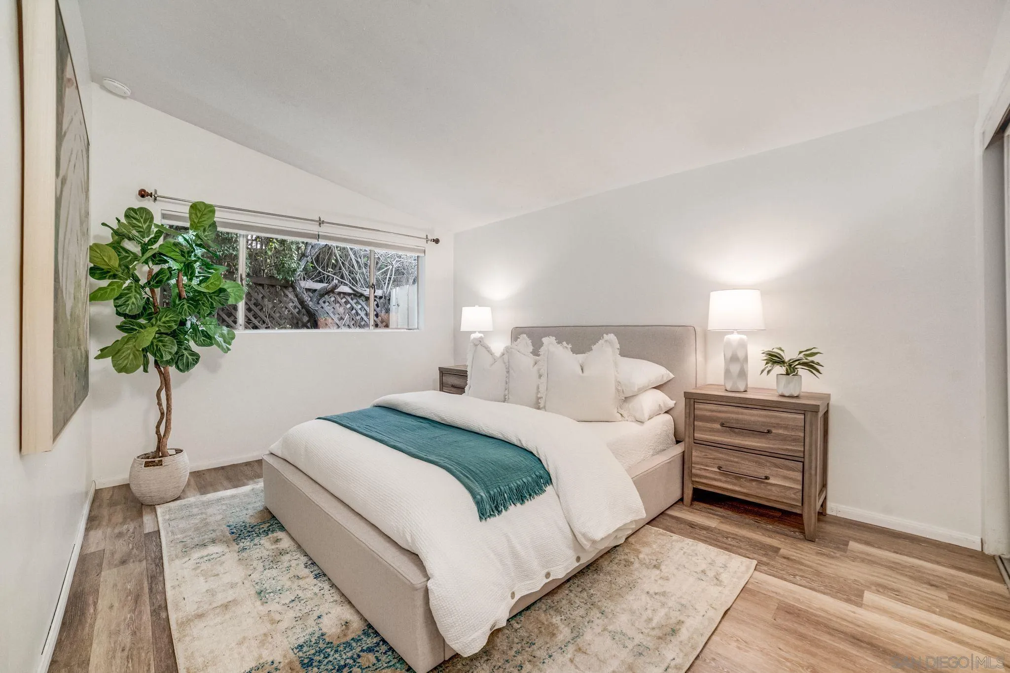624 8th Street Del Mar, CA 92014 - Photo 23 of 25 a bedroom with a bed and a potted plant