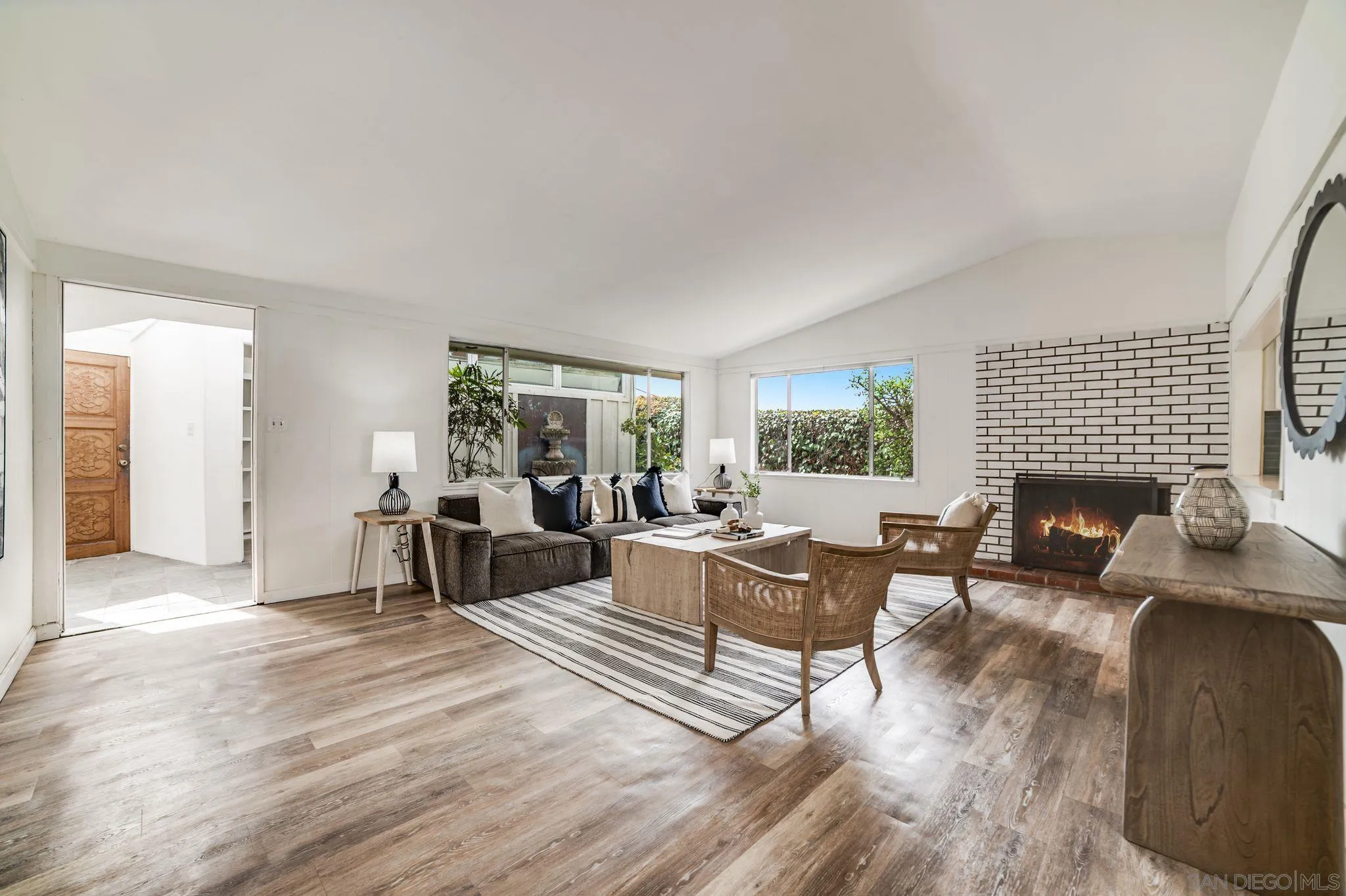 624 8th Street Del Mar, CA 92014 - Photo 5 of 25 a living room with furniture a large window and a fireplace