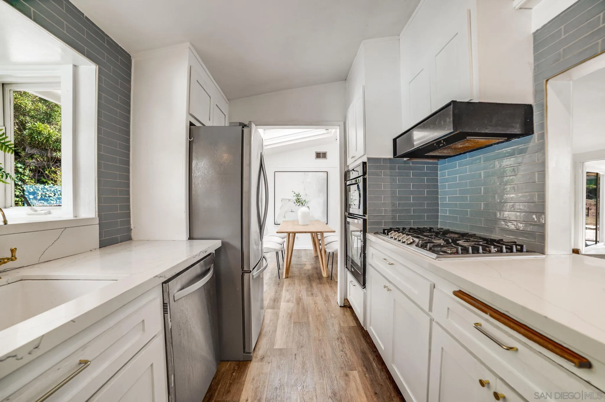 624 8th Street Del Mar, CA 92014 - Photo 9 of 25 a kitchen with a stove a sink and a refrigerator