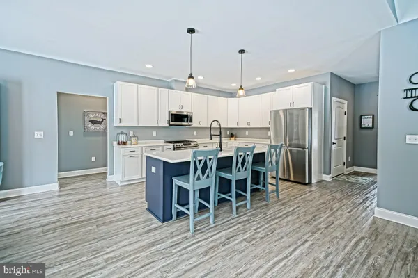 a kitchen with cabinets and a refrigerator