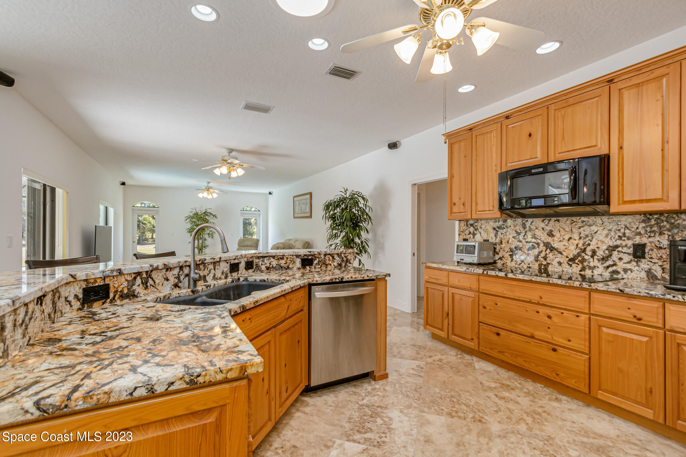 271 Deer Run Road Palm Bay, FL 32909 - Photo 3 of 61 a large kitchen with cabinets