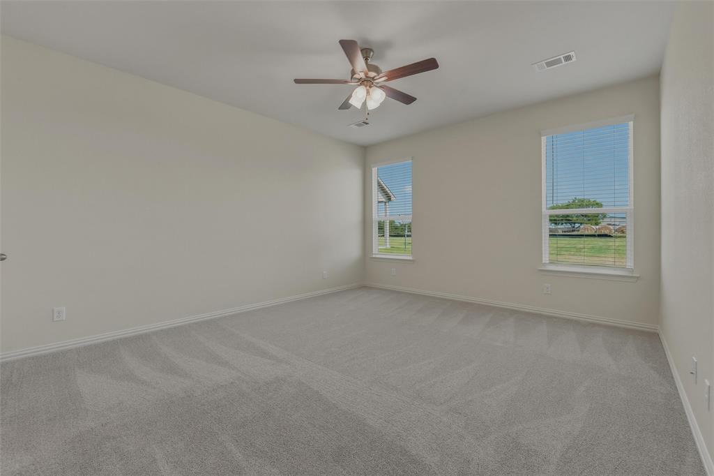1113 Trinity Drive Springtown, TX 76082 - Photo 18 of 40 Spacious room featuring light gray carpeting and neutral wall tones