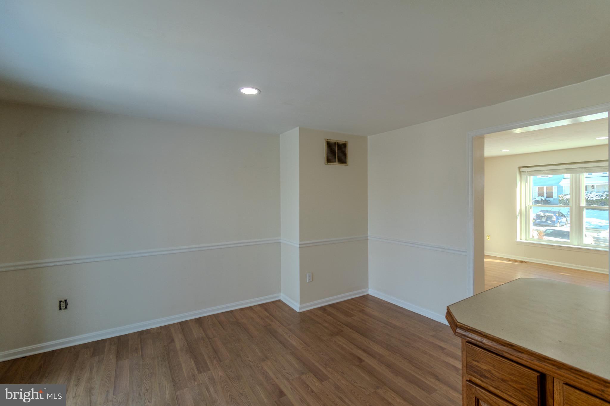 608 St Georges Station Road Reisterstown, MD 21136 - Photo 6 of 30 an empty room with wooden floor and windows