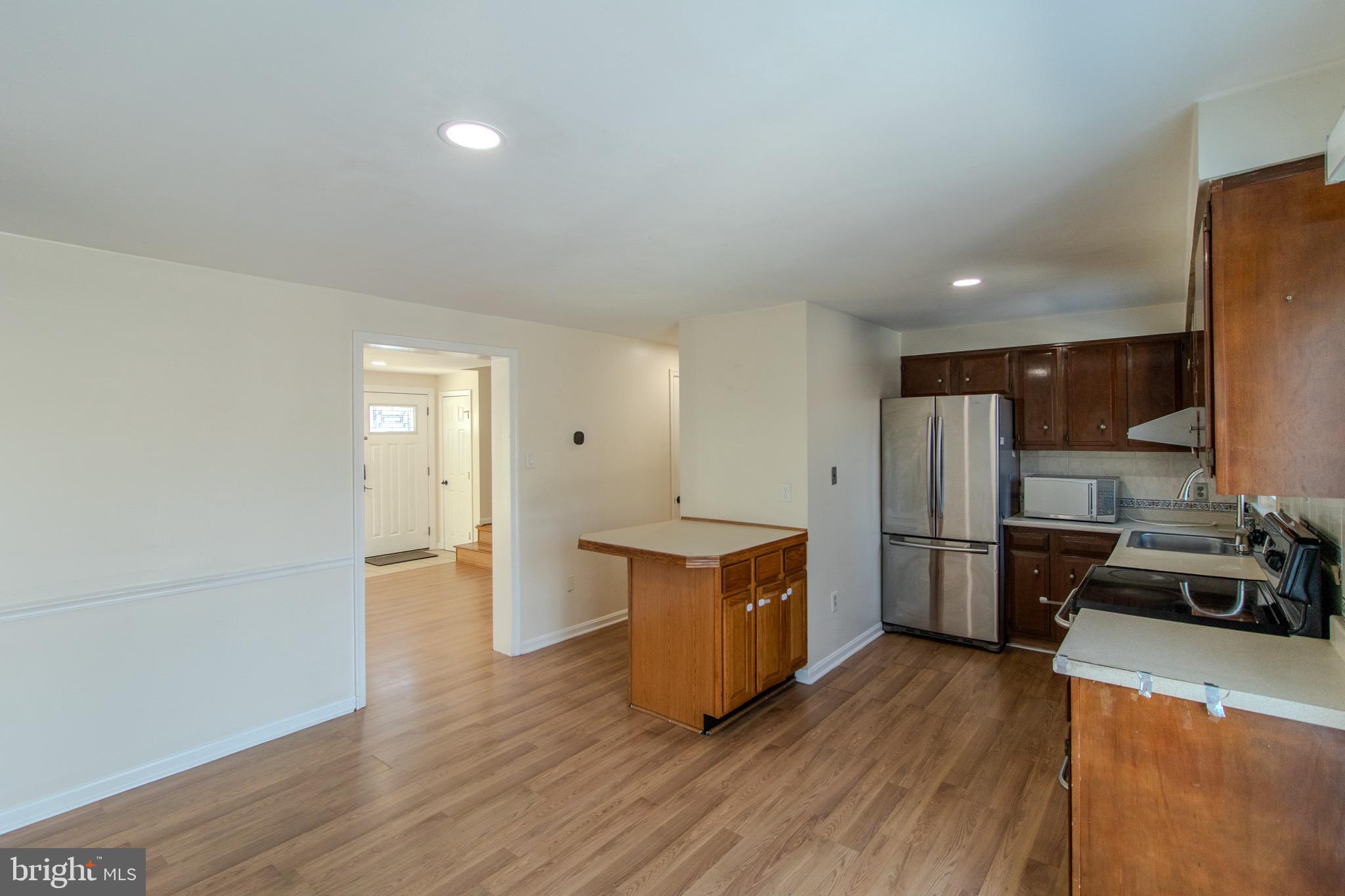 608 St Georges Station Road Reisterstown, MD 21136 - Photo 7 of 30 a kitchen with a refrigerator and a stove