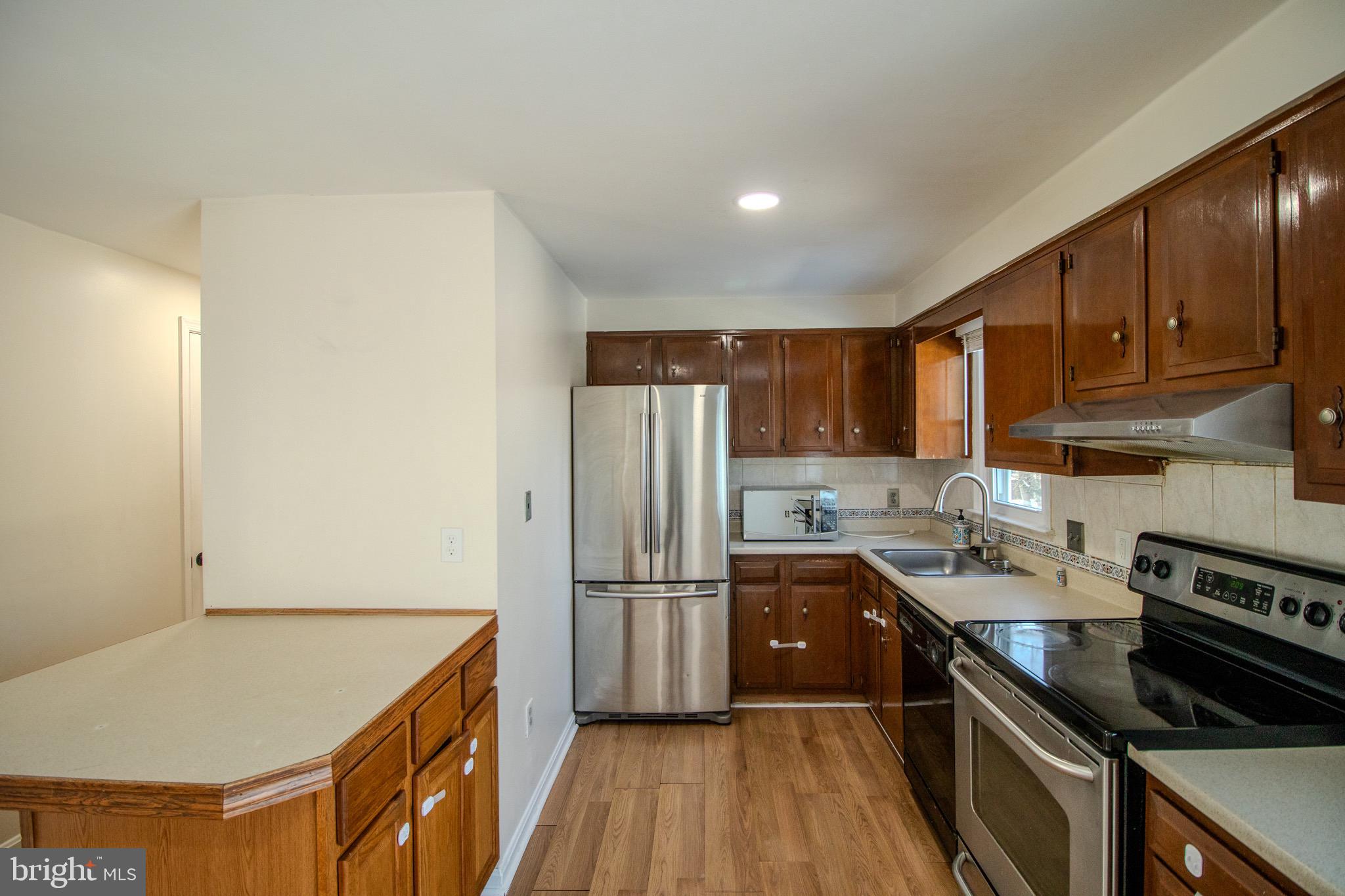 608 St Georges Station Road Reisterstown, MD 21136 - Photo 8 of 30 a kitchen with stainless steel appliances granite countertop a sink stove and refrigerator
