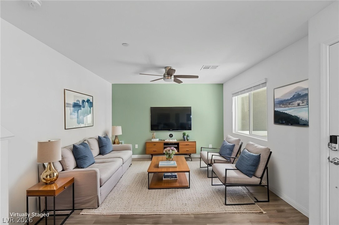 12367 Indigo Montage Road, Unit 3 Las Vegas, NV 89183 - Photo 2 of 33 This living room features elegant flooring and a ceiling fan, enhancing comfort and aesthetic appeal.