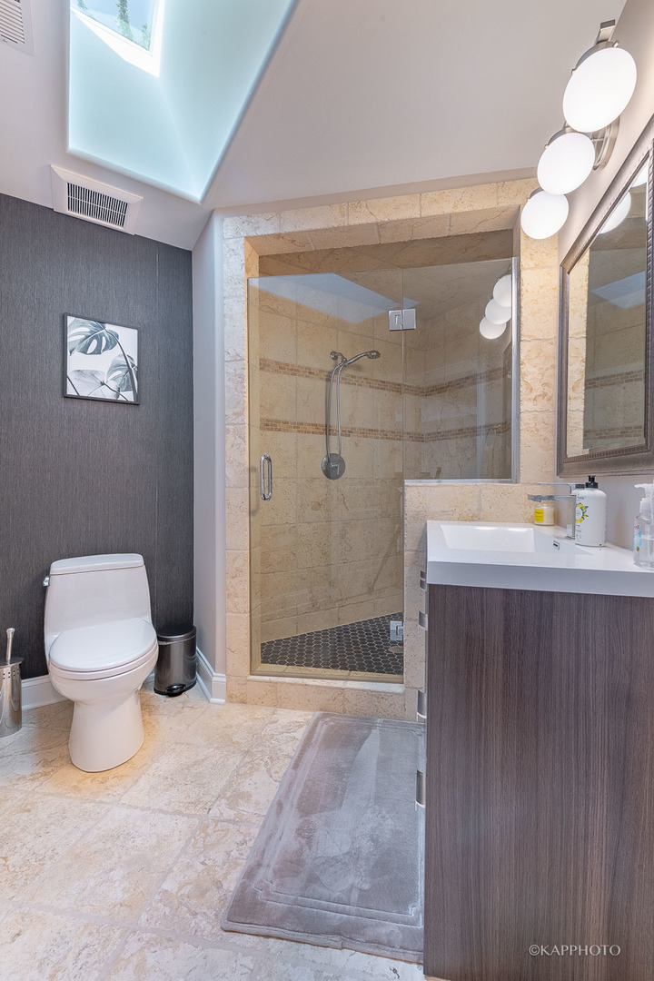 605 Elmdale Road Glenview, IL 60025 - Photo 22 of 36 a bathroom with a sink a toilet and shower