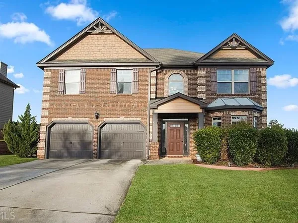 a front view of a house with a yard