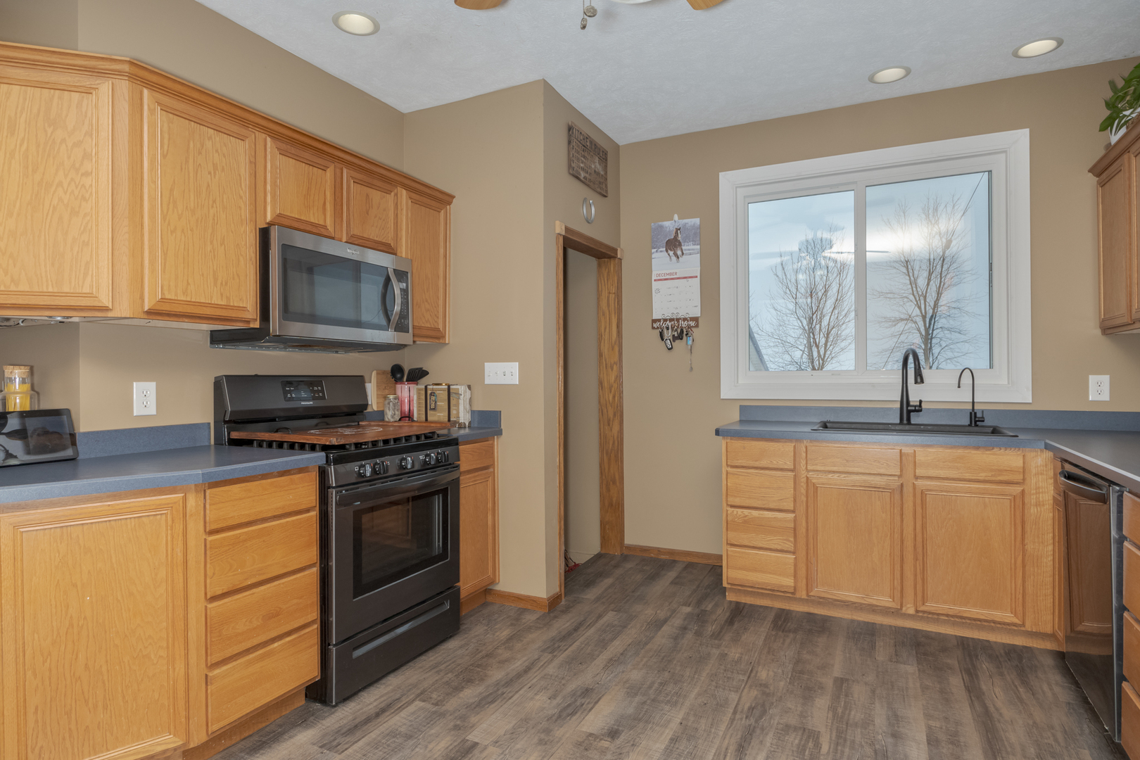 9948 North 100 E Road Gridley, IL 61744 - Photo 11 of 27 a kitchen with stainless steel appliances granite countertop a stove a sink and a microwave