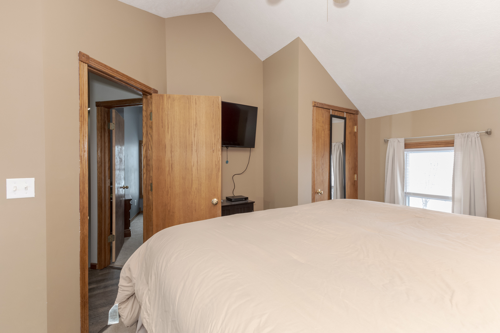 9948 North 100 E Road Gridley, IL 61744 - Photo 20 of 27 a bedroom with a bed and a flat tv screen on dresser