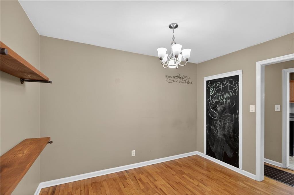 113 Maple Street Bremen, GA 30110 - Photo 13 of 23 a view of a hallway with wooden floor and chandelier
