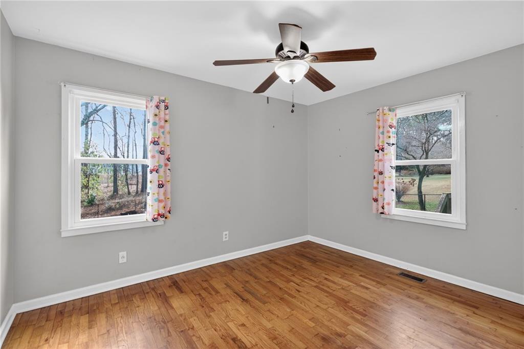 113 Maple Street Bremen, GA 30110 - Photo 15 of 23 a view of an empty room with wooden floor and a window