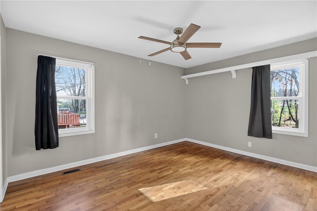 113 Maple Street Bremen, GA 30110 - Photo 16 of 23 a view of an empty room with wooden floor and a window