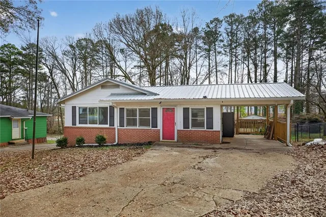 a front view of a house with a garden