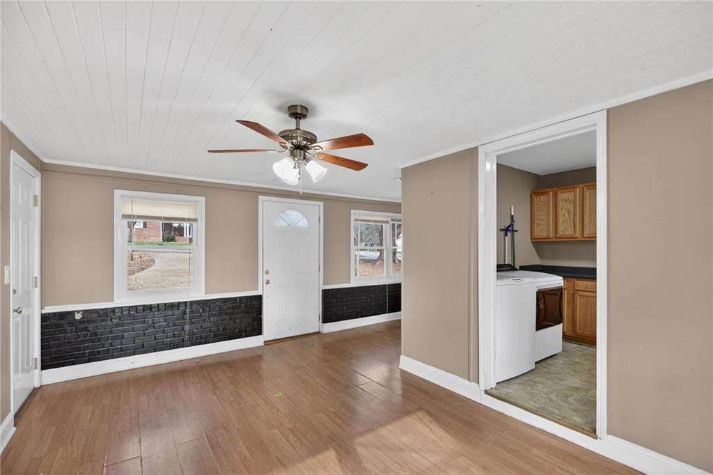 113 Maple Street Bremen, GA 30110 - Photo 6 of 23 a view of a livingroom with wooden floor and a ceiling fan