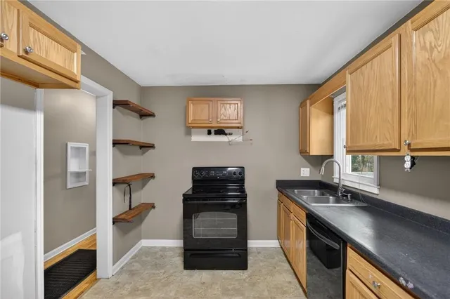 a kitchen with a refrigerator and a stove top oven