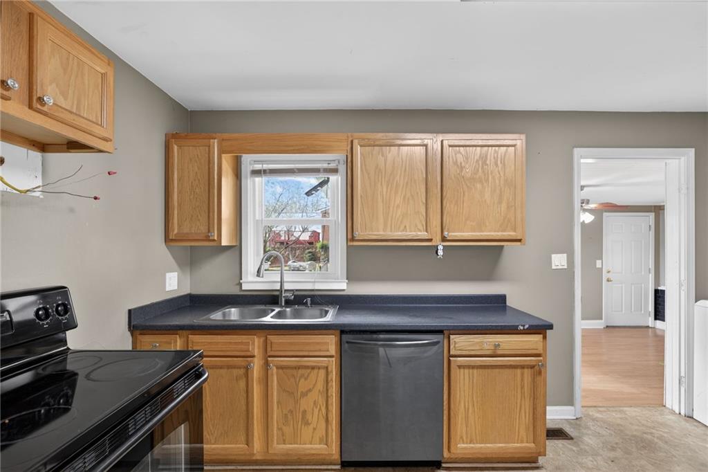113 Maple Street Bremen, GA 30110 - Photo 8 of 23 a kitchen with granite countertop a sink and a stove