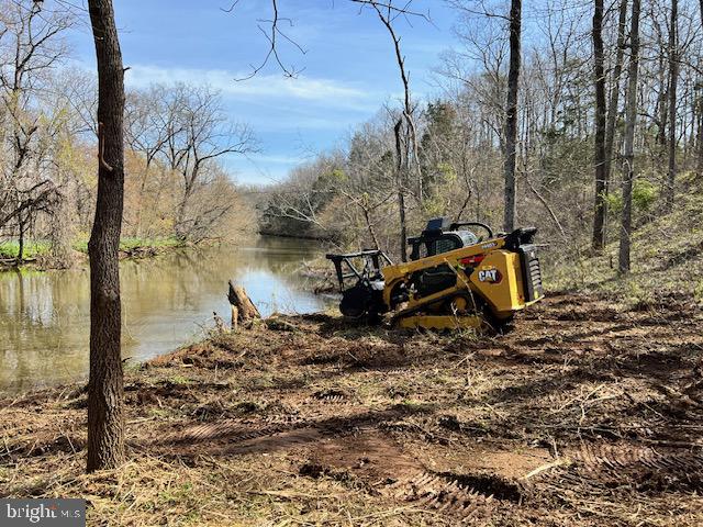 Machine leveling site at bank of Cedar Run