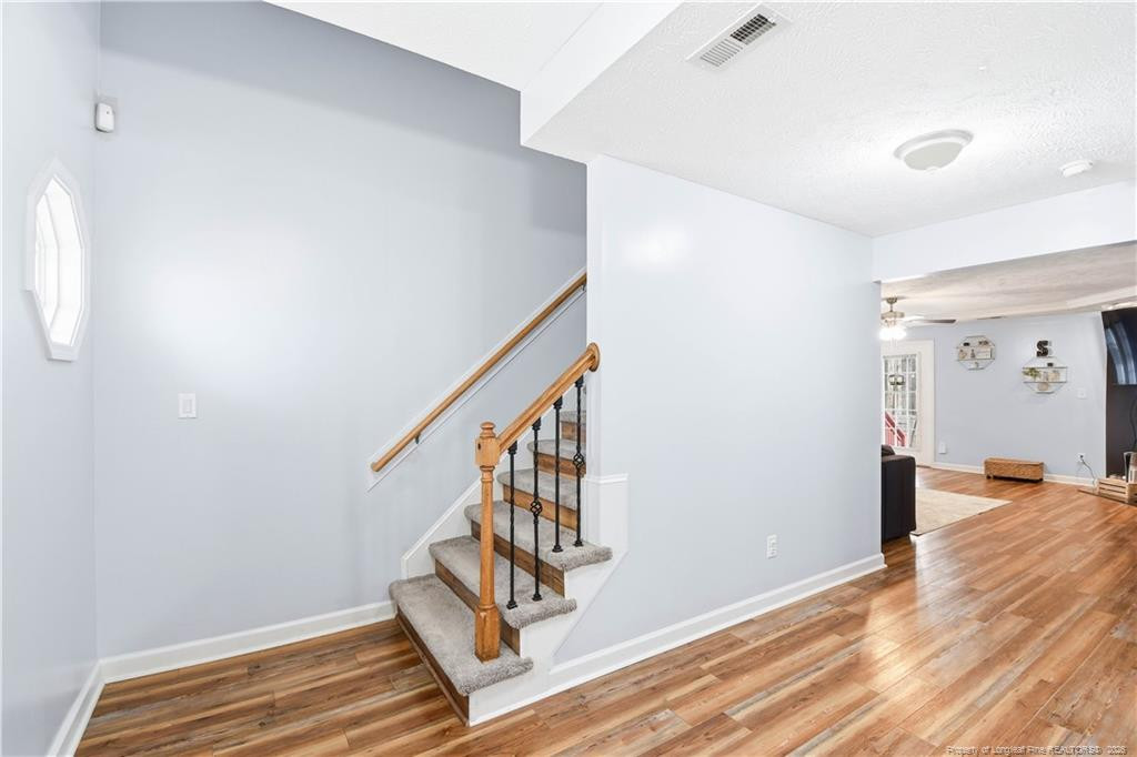 212 Lennox Loop Raeford, NC 28376 - Photo 6 of 47 a view of entryway with wooden floor