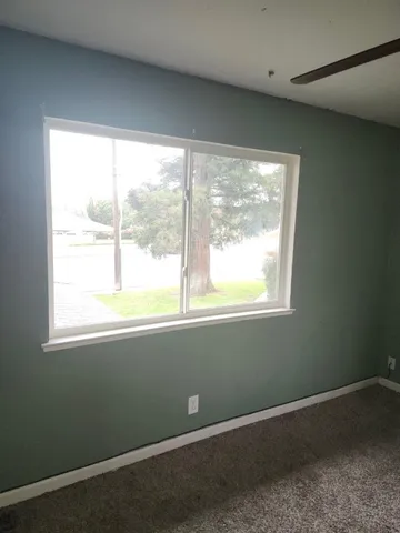 a view of an empty room with a window