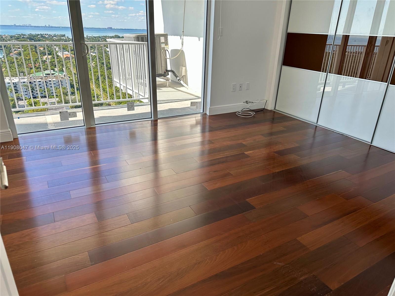 881 Ocean Drive, Unit 22E Key Biscayne, FL 33149 - Photo 12 of 16 a view of an empty room with wooden floor