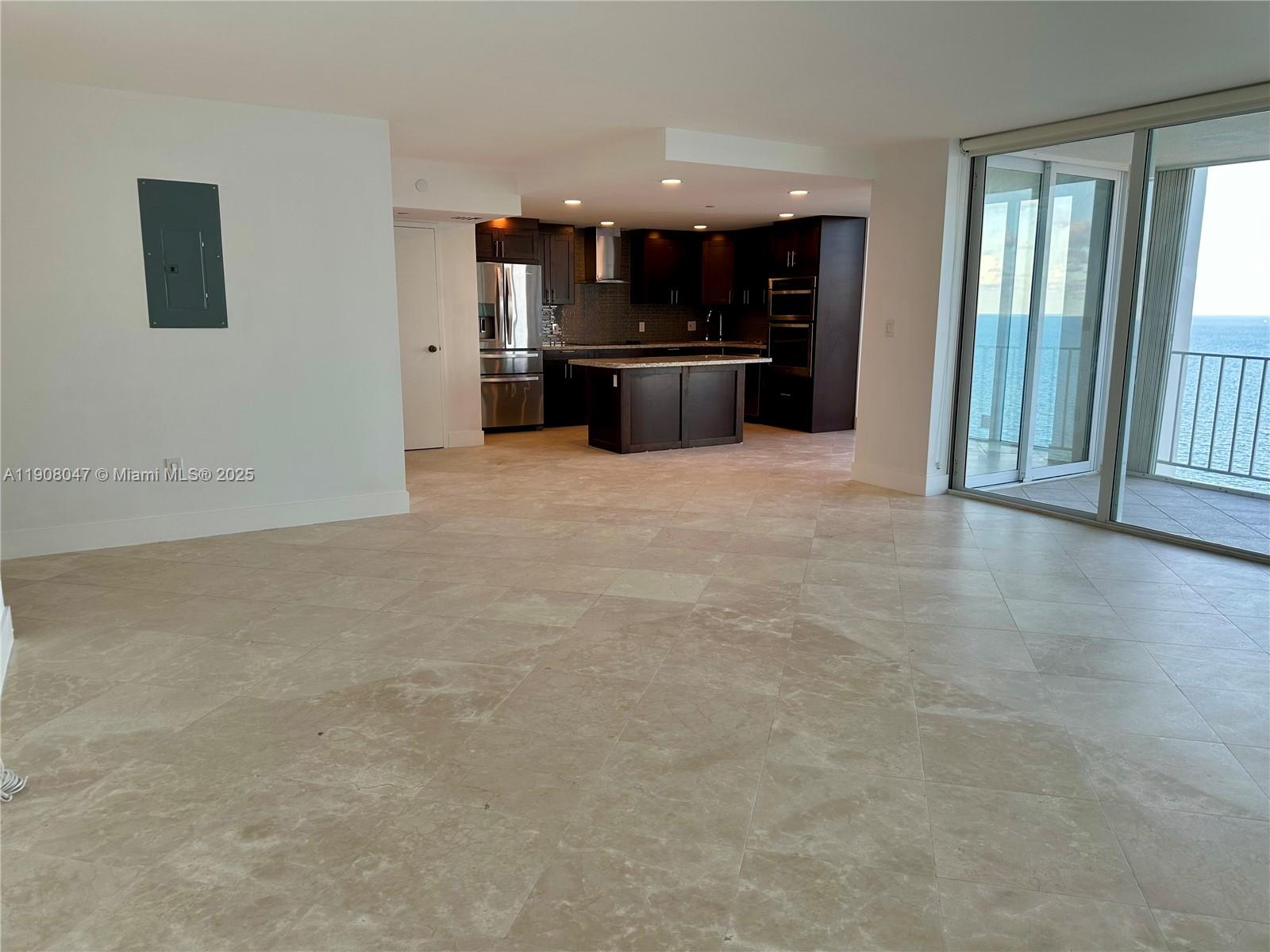 881 Ocean Drive, Unit 22E Key Biscayne, FL 33149 - Photo 8 of 16 an empty room with a kitchen and a sink
