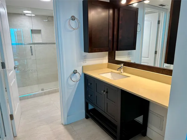 a bathroom with a double vanity sink a toilet and a mirror