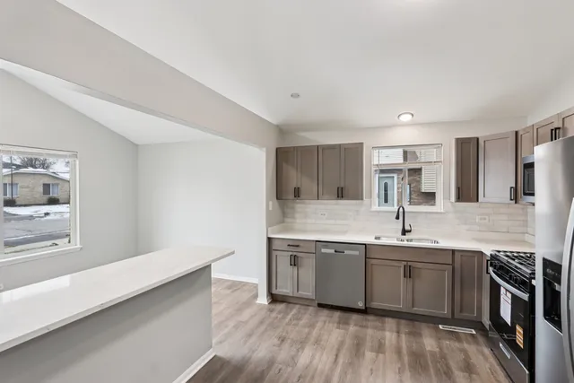 a kitchen with a sink stove and cabinets