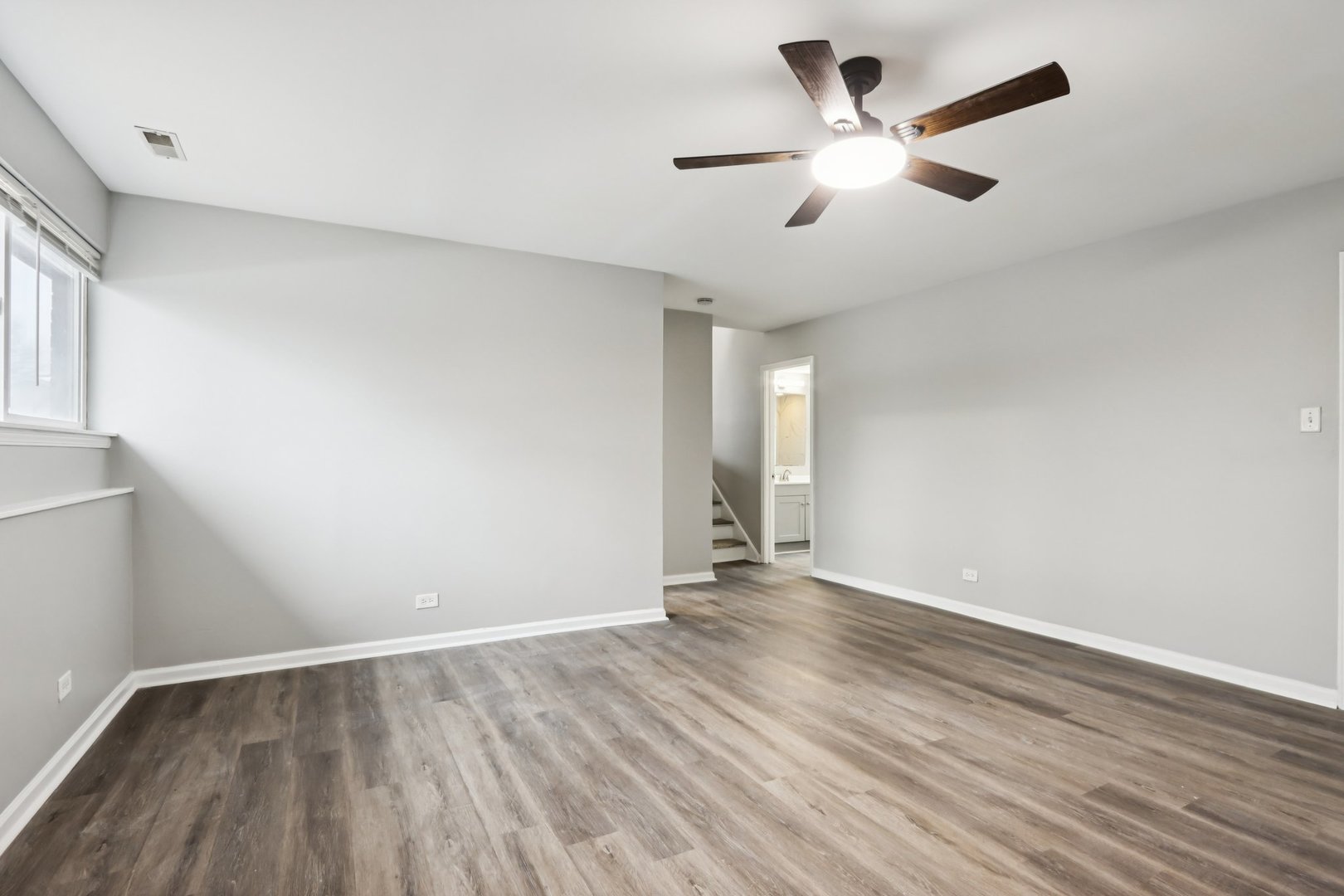 3348 Willow Lane Markham, IL 60428 - Photo 15 of 41 an empty room with wooden floor and ceiling fan