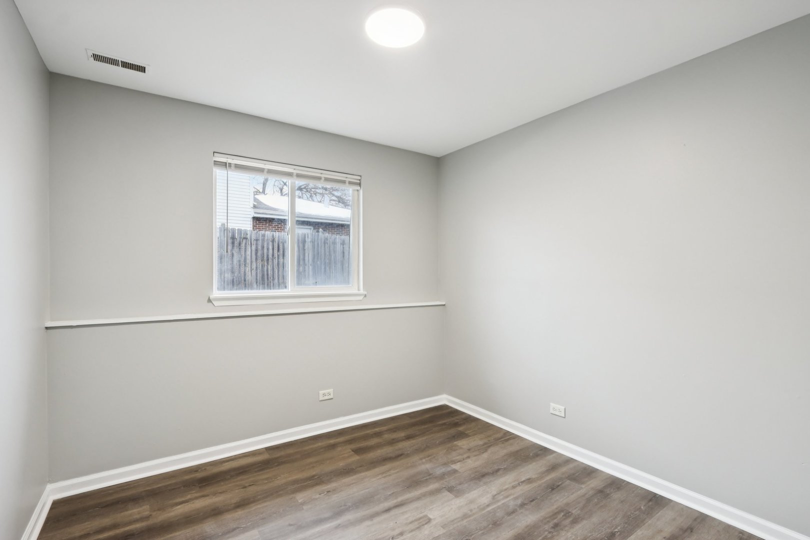 3348 Willow Lane Markham, IL 60428 - Photo 20 of 41 a view of an empty room with wooden floor and a window