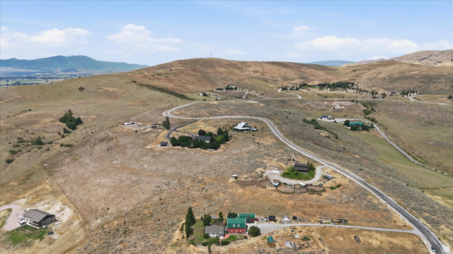 715 Ranch Loop Road Preston, ID 83263 - Photo 63 of 77 Expansive land parcel featuring undulating topography, a road, natural vegetation, distant mountains, and scattered residential structures