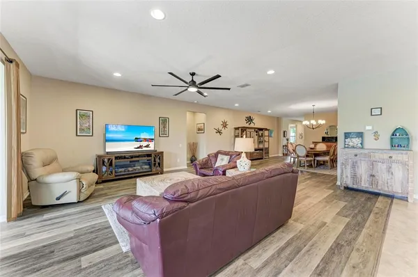 a kitchen with stainless steel appliances granite countertop a stove a refrigerator a oven a sink with a dining table and chairs