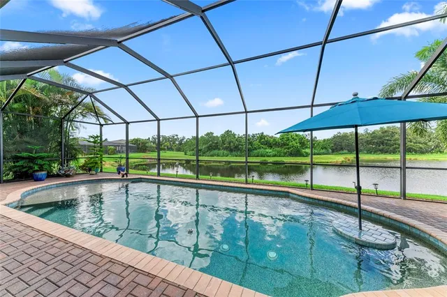 a bedroom with a bed and a flat tv screen on dresser