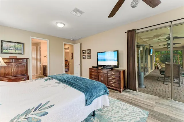 a view of swimming pool with seating space and trees in the background