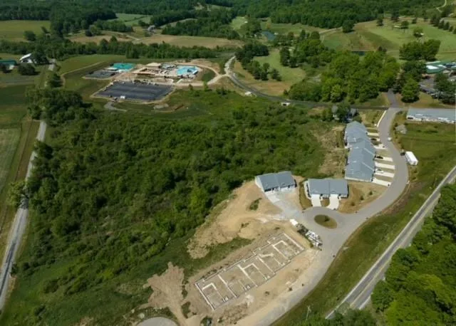 an aerial view of a house with swimming pool and outdoor seating