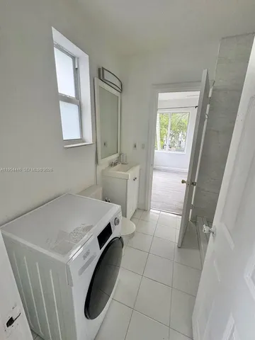 a room with washing machine and window
