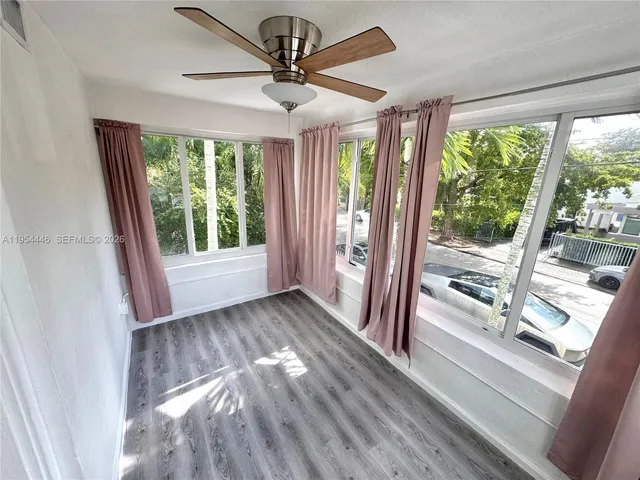 a view of hallway with furniture and a large window