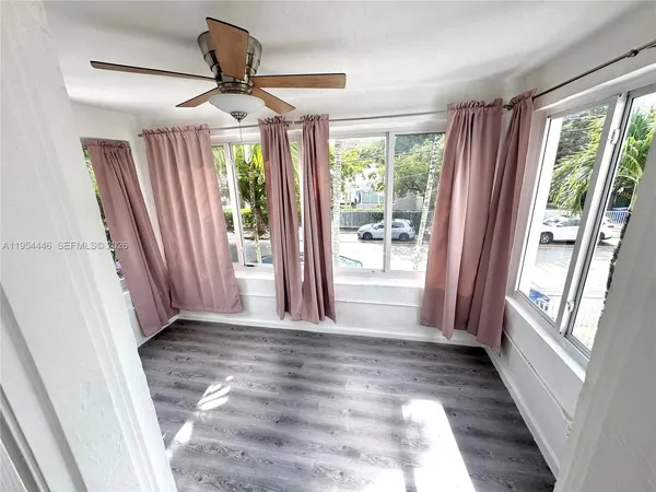 a view of entryway with window and wooden floor