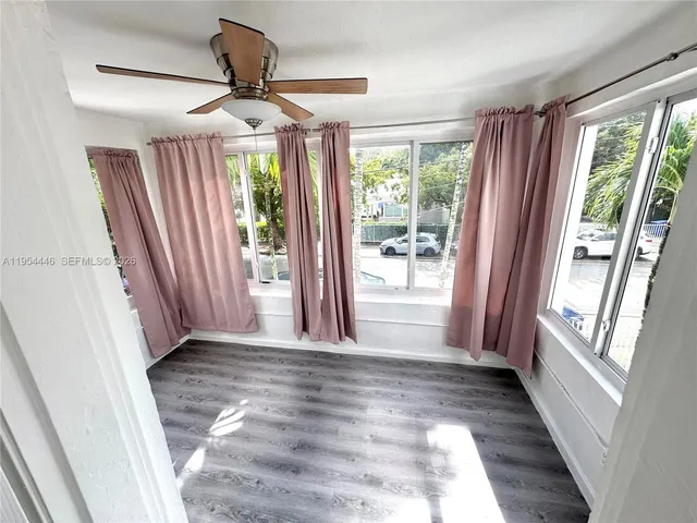 a view of entryway with window and wooden floor