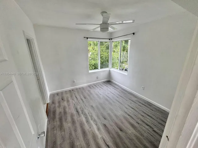 a view of room with window and hardwood floor