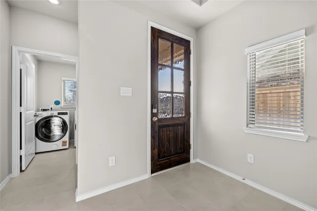 a view of a storage and utility room with washer and dryer