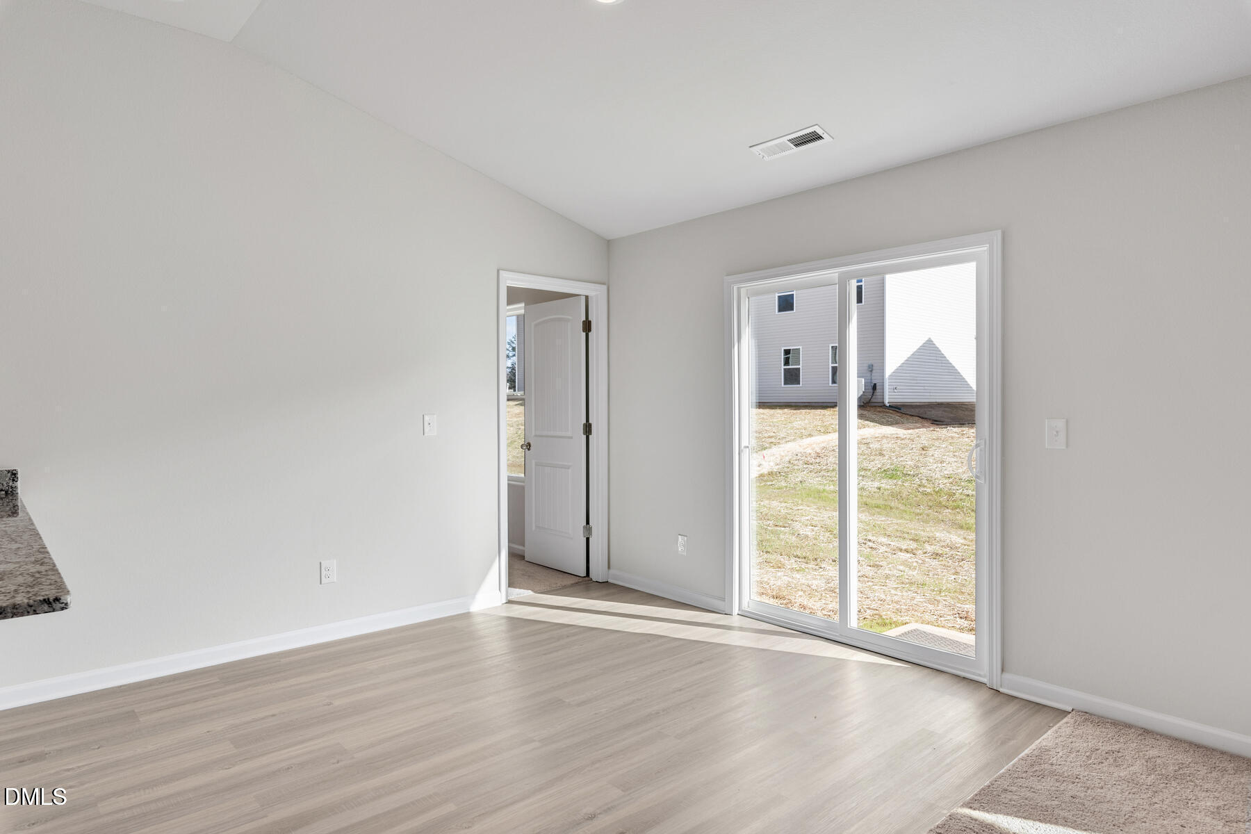 12 Crow Field Street Roxboro, NC 27574 - Photo 5 of 18 an empty room with wooden floor and sliding door