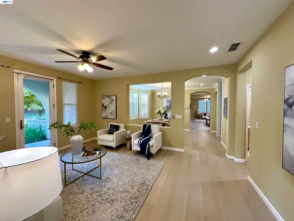 a living room with furniture and a chandelier