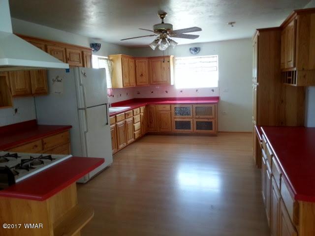 8559 Eagles Flight Road Show Low, AZ 85901 - Photo 3 of 22 a kitchen with stainless steel appliances granite countertop a refrigerator a stove and a sink