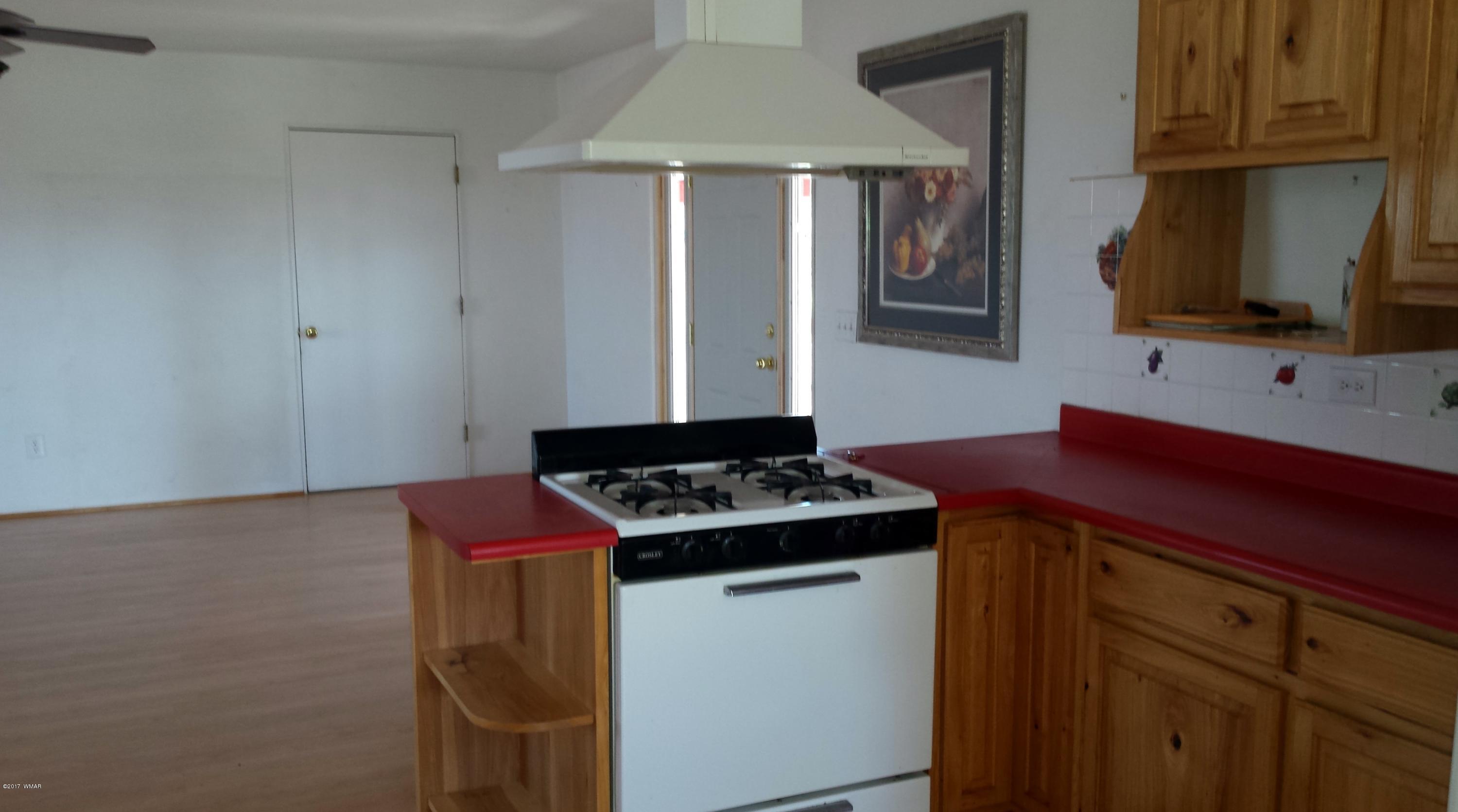 8559 Eagles Flight Road Show Low, AZ 85901 - Photo 6 of 22 a kitchen with a stove and a microwave