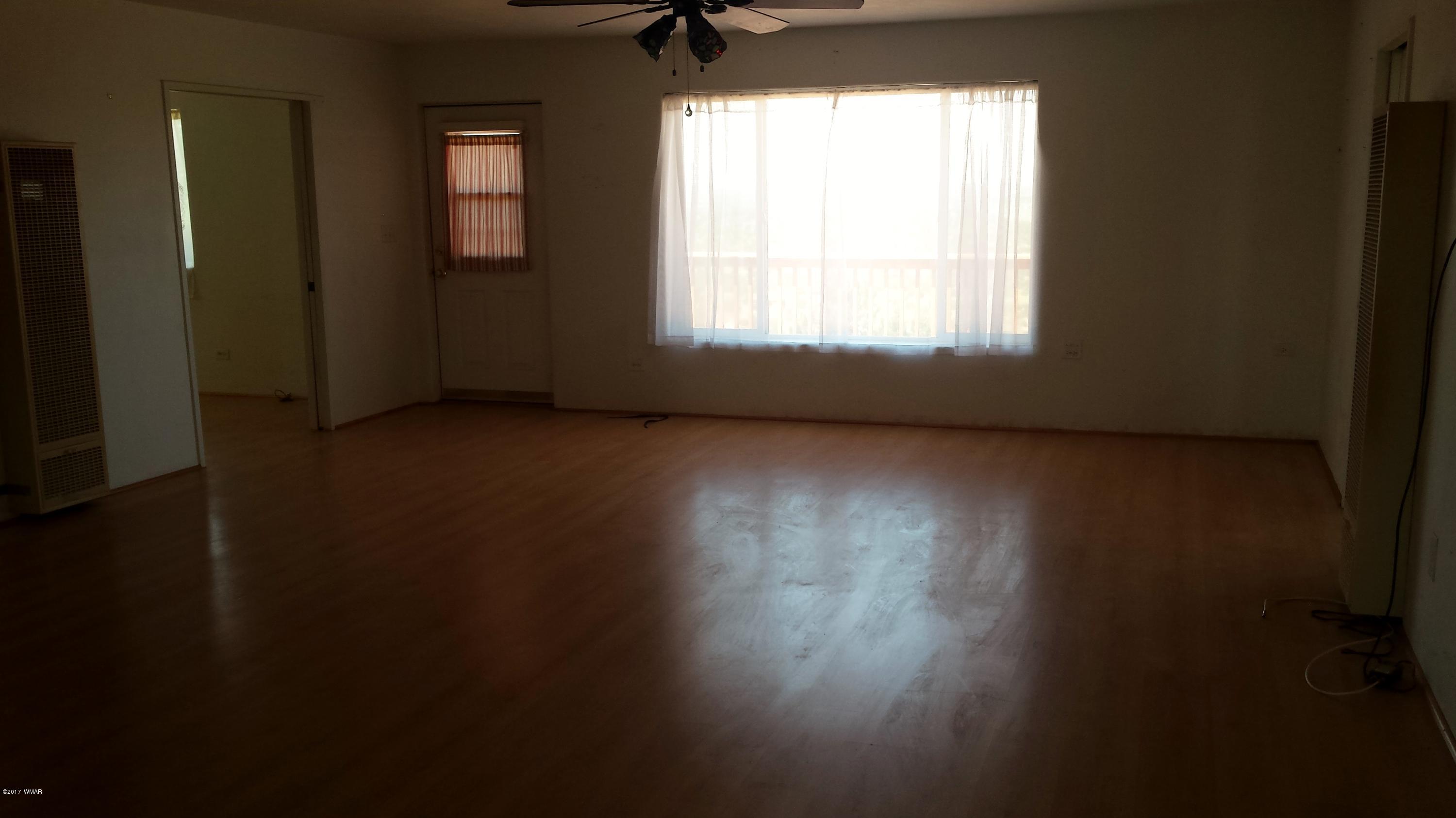 8559 Eagles Flight Road Show Low, AZ 85901 - Photo 8 of 22 a view of a livingroom with wooden floor and a window