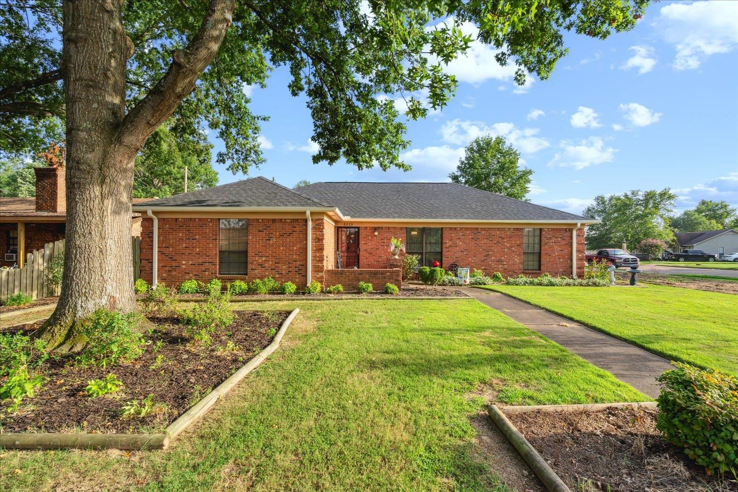 a front view of house with yard and green space