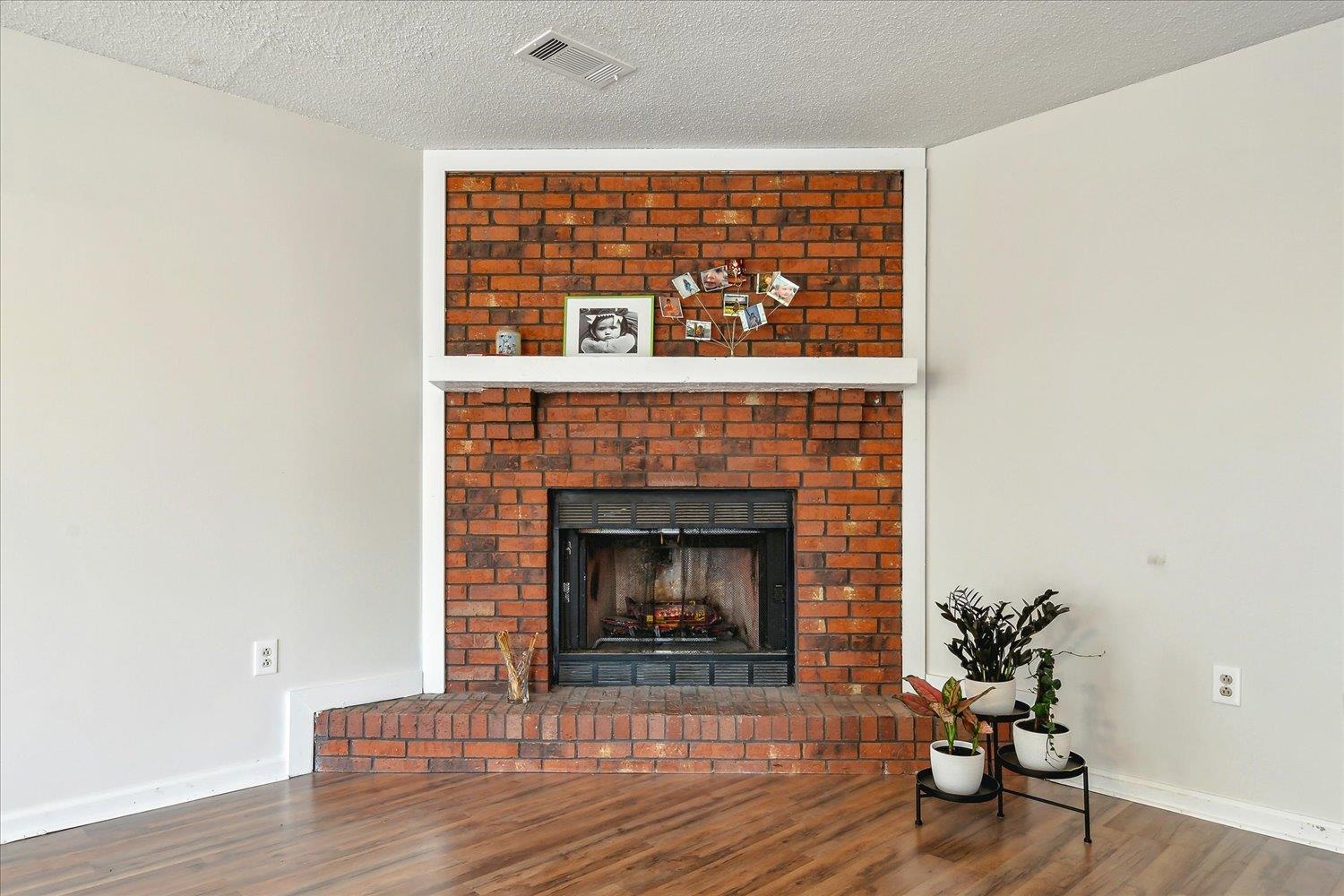 4419 Logan's Path Road Millington, TN 38053 - Photo 11 of 21 a living room with a fireplace and wooden floor
