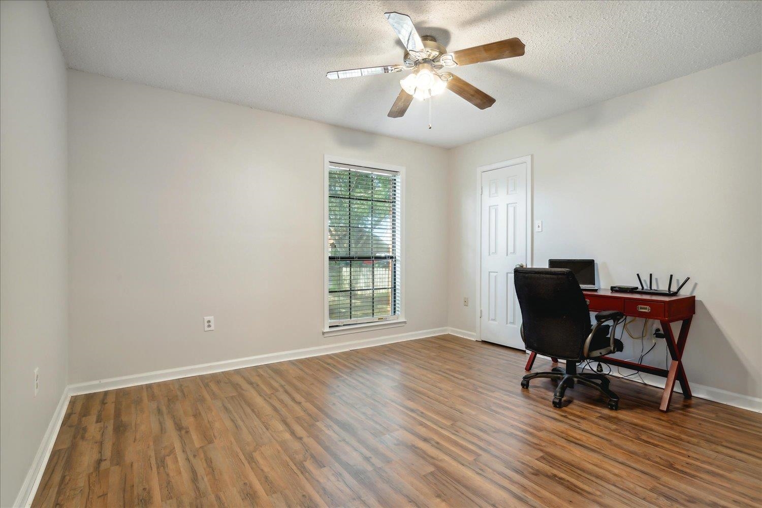 4419 Logan's Path Road Millington, TN 38053 - Photo 16 of 21 a view of a workspace with wooden floor and a window